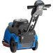 A blue and black Clarke AGM cordless walk behind floor scrubber with a handle and wheels.