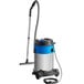 A Nilfisk stainless steel wet/dry vacuum with a hose attached.