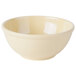 A butter yellow bowl with a white background.