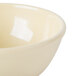 A Cal-Mil butter yellow melamine bowl with a white rim.