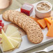 A cheese board with Carr's Whole Wheat Crackers, cheese, and grapes.