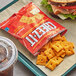 A tray with a sandwich, Cheez-It Reduced Fat crackers, and a drink.