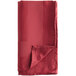 A folded Oxford burgundy cloth napkin on a white background.
