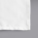 A white fabric napkin with a square edge.