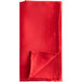 A red folded Oxford cloth napkin.