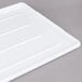 A white plastic Winholt Sani-Platter display tray on a gray surface.