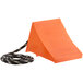 An orange block with a black rope attached to it.
