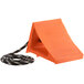 An orange block with an eye hook and black and white rope.