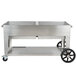 A large stainless steel Crown Verity outdoor grill on wheels.