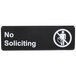 A black sign with white text that says "No Soliciting" by Thunder Group.