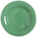 A close-up of a GET Diamond Mardi Gras rainforest green melamine plate with a white edge.