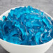A white bowl of blue gummy dolphins.