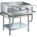 A stainless steel Cooking Performance Group gas griddle on a stainless steel Regency Equipment stand with shelves.