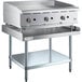 A stainless steel Cooking Performance Group gas griddle on a stainless steel Regency Equipment stand with knobs.