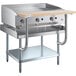 A stainless steel Cooking Performance Group gas griddle on a wooden top chef station.