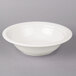 A CAC porcelain serving bowl in white on a gray surface.