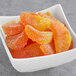 A white bowl filled with Kervan sugared orange gummy slices.