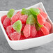 A bowl filled with red and green Kervan sour gummy cherries.