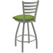 A Holland Barstool Jackie swivel bar stool with a green cushion and metal frame.