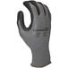 A close-up of a Cordova Conquest gray warehouse glove with black and gray palm coating.