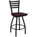 A black Holland Bar Stool ladderback swivel bar stool with a dark cherry maple seat.