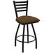 A black Holland Bar Stool ladderback swivel bar stool with a brown cushion.
