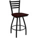 A black Holland Bar Stool ladderback swivel bar stool with a dark cherry oak seat.