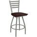 A Holland Bar Stool Jackie ladderback swivel counter stool with a dark cherry seat and an anodized nickel frame.