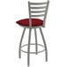 A white Holland Bar Stool ladderback swivel bar stool with red cushion and a silver frame.