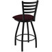 A Holland Bar Stool black Ladderback swivel bar stool with a red cushion.