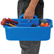 A man holding a blue Quantum tool caddy with tools in it.