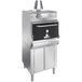 A close-up of a large stainless steel Mibrasa charcoal oven with a black door.