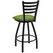 A black Holland Bar Stool ladderback swivel bar stool with a green cushion.