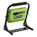 A green and black PowerSmith rechargeable LED work light on a stand with a charger.