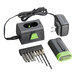 A black and green Genesis cordless screwdriver with a battery charger and bits.