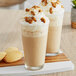 Two glasses of Frozen Bean Cookie Butter Latte blended ice coffee with whipped cream and cookies.