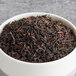 A bowl of Davidson's Organic Oothu Black Loose Leaf Tea.