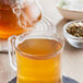 A glass mug of Davidson's Organic Tulsi Signature Spice herbal tea.