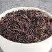 A bowl of brown Davidson's Organic Quilan China Oolong Loose Leaf Tea.