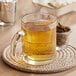 A glass mug of Davidson's Organic White Orange with Clove tea on a table.