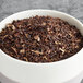A bowl of Davidson's Organic Decaf Earl Grey loose leaf tea on a table.