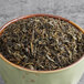 A bowl of Davidson's Organic Mao Jian Jasmine green tea leaves.