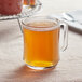A glass mug of Davidson's Organic Pumpkin Spice Loose Leaf Tea on a table.