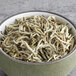 A bowl of Davidson's Organic Silver Needles white tea leaves.