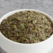 A bowl of green and brown Davidson's Organic Guayusa Herbal loose leaves.