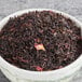 A bowl of red Davidson's Organic Strawberry Essence loose leaf tea.