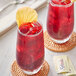 Two glasses of Davidson's Organic Hibiscus Iced Tea with a yellow leaf garnish.