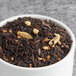 Davidson's Organic Mandarin Chai with Anise Loose Leaf Tea in a white bowl on a table.