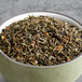 A bowl of Davidson's Organic Jasmine Almond with Orange Loose Leaf Tea on a table.