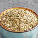 A bowl filled with Davidson's Organic Mezclado de Mate Herbal loose leaf tea on a table.
